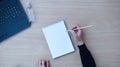 Blank paper notebook and female hands with pencil. Top view. Royalty Free Stock Photo