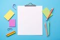 Blank paper notepad mockup with school supplies on blue background. Flat lay, top view, copy space. Back to school. Royalty Free Stock Photo