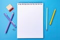 Blank paper notepad mockup with school supplies on blue background. Flat lay, top view, copy space. Back to school. Royalty Free Stock Photo