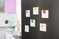 Blank paper notes and magnets on refrigerator door Royalty Free Stock Photo