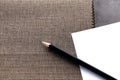 Blank paper with pencil on sample fabric Royalty Free Stock Photo
