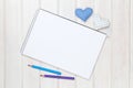 Blank paper, pencils and valentines day heart shaped toys on the