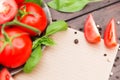 Blank paper for recipe or notes with ripe sweet tomatos Royalty Free Stock Photo