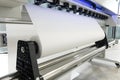 Blank paper roll in large printer format inkjet machine for industrial business Royalty Free Stock Photo