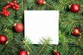 Paper sheet with Christmas decoration on fir tree branches as background Royalty Free Stock Photo