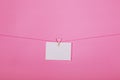 Blank paper sheets on a clothes line on a pink background. Pink hearts on clothespegs. Valentines day, Mother Day concept. Royalty Free Stock Photo