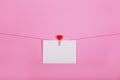 Blank paper sheets on a clothes line on a pink background. Red hearts on clothespegs. Valentines day, Mother Day concept. Royalty Free Stock Photo