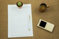 Blank paper with smart phone pen and coffee cup on wooden table, business concept Royalty Free Stock Photo