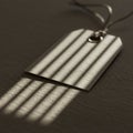 A blank paper tag with a grommet and string rests on a textured surface. Diagonal Royalty Free Stock Photo