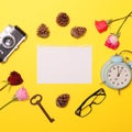 Blank paper with various objcects around it on yellow background - Trendy minimal flat lay concept Royalty Free Stock Photo