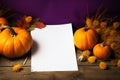 Blank paper waits for inspiration alongside vibrant autumn pumpkins