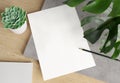 Blank paper on wooden desk Mockup. 3d rendering of A4 empty white sheet on concrete plate with monstera plant, cactus and pencil