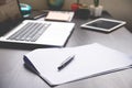 Blank Papers with pen,tablet and laptop on the desk.