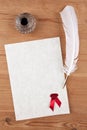 Blank parchment paper with red wax seal quill and ink well