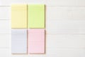 Blank pastel yellow green pink color reminder paper pad with horizontal line stripes copy space on white pine wood