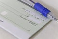 A Blank Personal Cheque with a pen Royalty Free Stock Photo