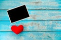 Blank photo frame album and red heart on blue wood background Royalty Free Stock Photo