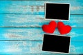 Blank photo frame album and red heart on blue wood background Royalty Free Stock Photo