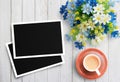 Blank photo frame and flower with cup of coffee on white wood ba Royalty Free Stock Photo