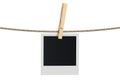 Blank photo frame hanging on a rope, 3D rendering Royalty Free Stock Photo
