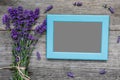 Blank photo frame with lavender flowers bouquet on rustic wooden table. flat lay. mock up. festive background Royalty Free Stock Photo