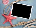 Blank photo frame with seashells, ship rope, sea stones Royalty Free Stock Photo