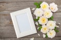 Blank photo frame and white roses Royalty Free Stock Photo