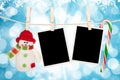 Blank photo frames and snowman hanging on the clothesline Royalty Free Stock Photo