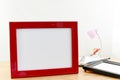 Blank photo frames on wooden table and white background. Royalty Free Stock Photo