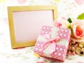 Blank photo wood frame with pink roses and gift box decorated flower background Royalty Free Stock Photo