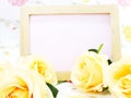 Blank photo wood frame with pink roses and gift box on sweet flower background Royalty Free Stock Photo