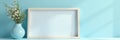 Blank picture frame on light blue; plants and vase, template, clean, simple Royalty Free Stock Photo
