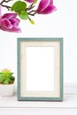 The Blank picture frame with magnolia flower on white floor with copy space and clipping path for the inside Royalty Free Stock Photo
