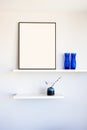 Blank picture frame mockup on a wall. Vertical orientation. Artwork template in interior design Royalty Free Stock Photo