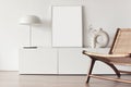 Blank picture frame mockup on white wall. White living room design. View of modern scandinavian style interior