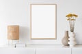 Blank picture frame mockup on white wall in minimal modern interior design. Royalty Free Stock Photo