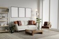 Blank 3 picture frame mockup on white wall. Modern living room design. View of modern Scandinavian style interior with Royalty Free Stock Photo