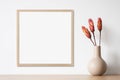 Blank picture frame mockup on white wall, template for square artwork. View of modern minimal style interior with canvas