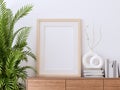 Blank picture frame on wooden cabinet with white wall background 3d render