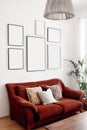 Blank picture frames mockups on white wall. White living room design. View of modern boho, scandi style interior with Royalty Free Stock Photo