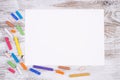 Blank piece of paper with colorful crayons on kid`s desk
