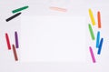 Blank piece of paper with colorful crayons on kid`s desk Royalty Free Stock Photo