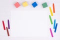 Blank piece of paper with colorful crayons on kid`s desk, top view with copy space Royalty Free Stock Photo