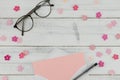 Blank pink card in white envelope, pen and eyeglasses Royalty Free Stock Photo