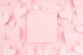Blank pink square page with paper hearts on light background. Advertising concept for Valentine day.