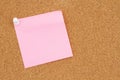 Blank pink sticky note on a bulletin board Royalty Free Stock Photo