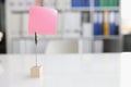 Blank pink sticky note on desktop closeup Royalty Free Stock Photo