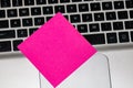 Blank pink sticky note, post it on keyboard. Close up Royalty Free Stock Photo