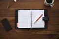 Blank planner on wooden desk