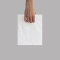 Blank plastic bag mock up holding in hand. Empty polyethylene pa